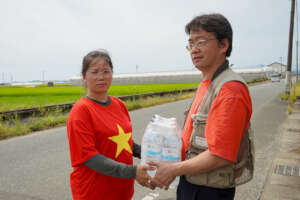 A Vietnamese woman recieving bottled water