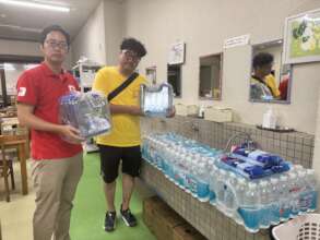 AAR staff Namatame delivering relief items