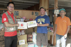 Staff members smiling after receiving relief items