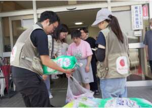 Namatame of AAR handing supplies (left)