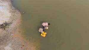 Children facing water from unsafe river