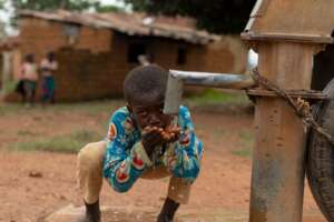 A little Ataaba drinking from manual pump borehole