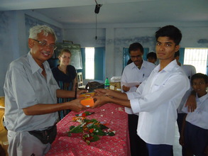 Kushal, Project Resource Person distributes a lamp
