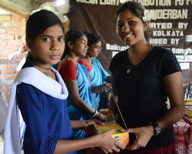 Donor, Rachel Ann Garibsingh handing over a lamp