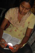 Studying by the light of a solar lamp