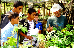 Tony teaching children about tree seedlings