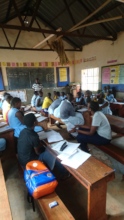 Mariam intern student in black conducts the survey