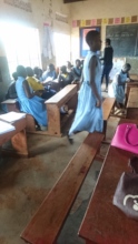 Natasha distributes educational survey forms