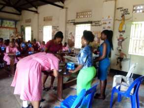 UYSTO field team distributing pads to the girls