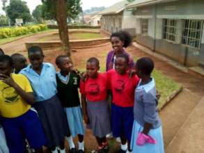 Global visitor posing for a photo with the team