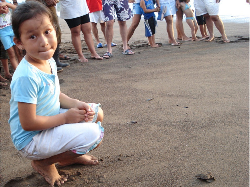 A local girl releasing hatchlings