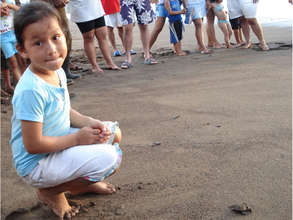 A local girl releasing hatchlings