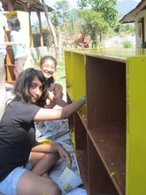 JIS students helping to repaint the shelves