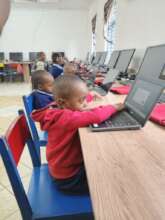 A picture of a young learner wearing a red uniform