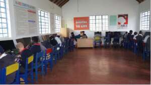 Students wearing uniforms sit in a classroom