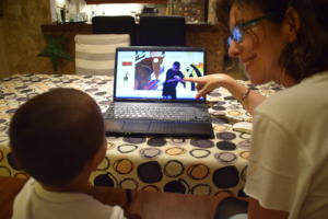 Hearing mother with deaf child enjoying videobooks