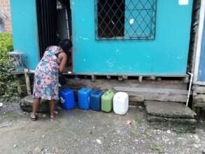 Collecting water in plastic jugs