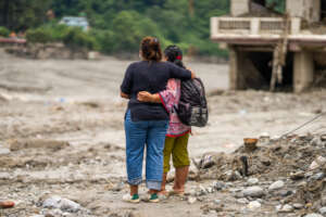 Two sisters survey the damage caused by the flood.