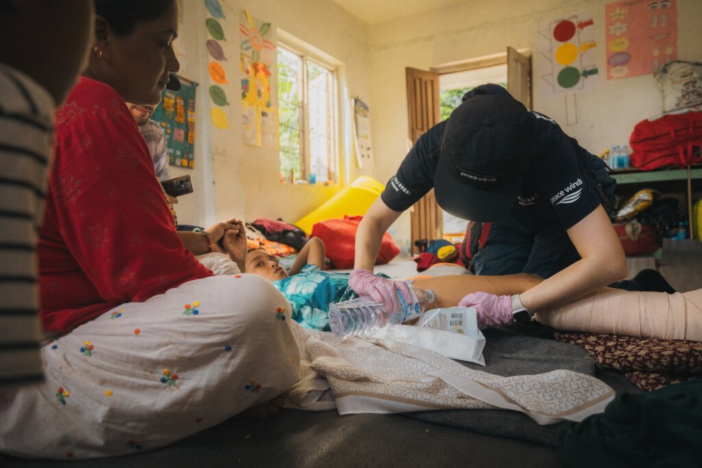 Peace Winds' nurse performs medical care