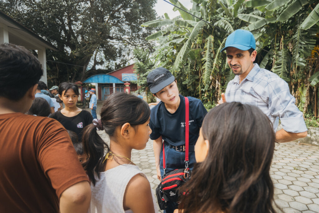 Peace Winds' nurse with local children