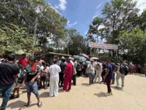 Evacuees wait outside evacuation center