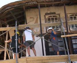 Volunteers begin repair of lime plaster wall