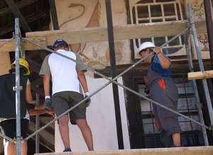 Trainees documenting visible painting under eaves
