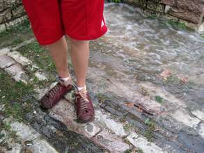 Rain runs down stone streets during deluge