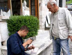 Student & instructor work on stone detailing