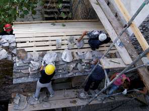 Trainees lay new stone roof over entry gate