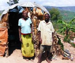 A couple stands in front of their current home