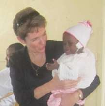 Little Jolie held by visiting team member
