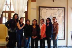 Dr. Apata in orange with dental hygienists