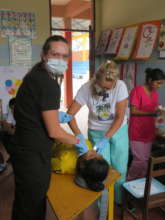 Sandy in blue at makeshift classroom exam table