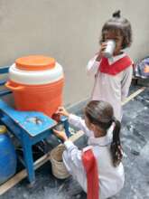 children drinking water in school