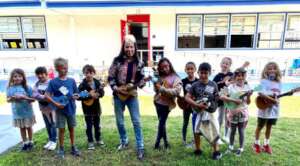 GITC Teaching Artist with elementary strummers