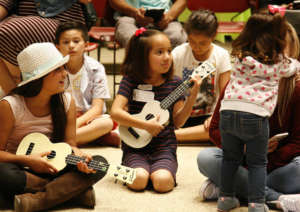 Children lead songs for their families in June!