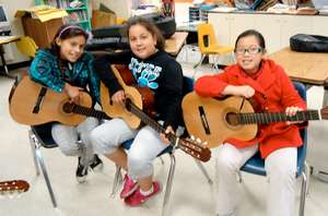 students play guitar during social studies
