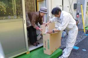 Woman Receives Heater at Temporary Housing Unit