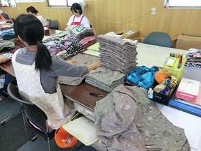 The facility user folds and bags the clothes
