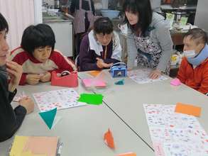 People at Nozomi workshop practicing paper folding