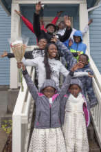 A happy family in front of their new home
