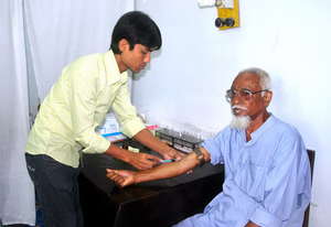 A Lab Technitian is taking blood for tests
