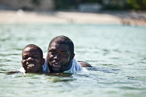 Samuel taking his first swim on Gary's back