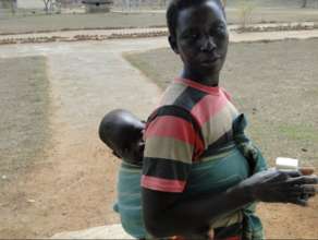 A new mother outside of the AUCF clinic