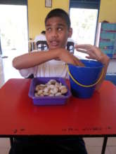 Counting pebbles enhance his tactile skills.