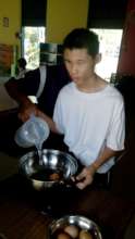 Chee is boiling an egg.