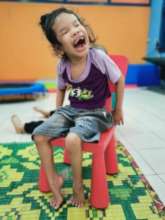 Rosy happy sitting on the chair with happy face