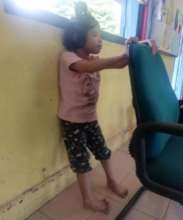 Rosy is standing with the support of the chair
