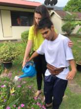 Daniel is watering the plants